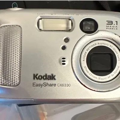 Sale Photo Thumbnail #28: Vintage Kodak EasyShare CX6330 3.1 megapixel digital camera in a silver finish, showing minor cosmetic surface wear.