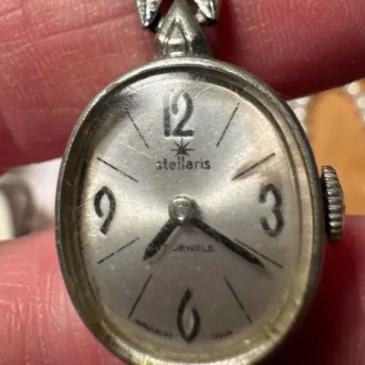 Sale Photo Thumbnail #31: Vintage Stellaris 17-jewel women's cocktail watch with an oval silver-tone case and brushed dial.