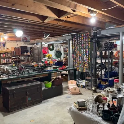 Sale Photo Thumbnail #10: model train layout, vintage trunks, bookshelves, and various tabletop collectibles.