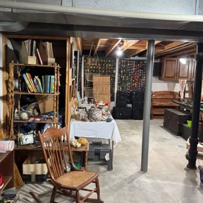 Sale Photo Thumbnail #11: vintage household items, including a cane-seat rocking chair, wooden bookshelves, luggage, and cookware.