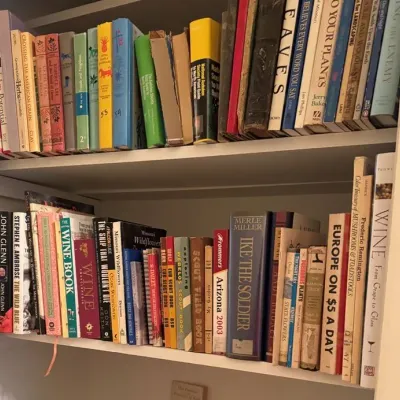Sale Photo Thumbnail #19: Collection of vintage hardback and paperback books, including nature guides, histories, travel books, and scout field books.