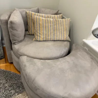 Sale Photo Thumbnail #40: Contemporary round swivel armchair with matching crescent-shaped ottoman, upholstered in light gray microfiber velvet and styled with patterned accent pillows.