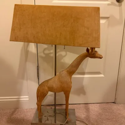 Sale Photo Thumbnail #52: Whimsical table lamp featuring a standing carved wood giraffe figure on a chrome-finished base, paired with a wide rectangular shade.