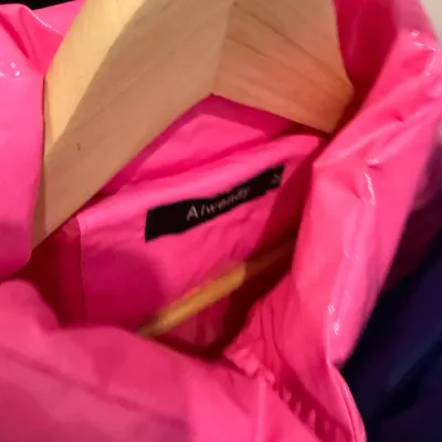 Sale Photo Thumbnail #70: Bright hot pink puffer jacket by AIWENTY, displayed on a wooden hanger.