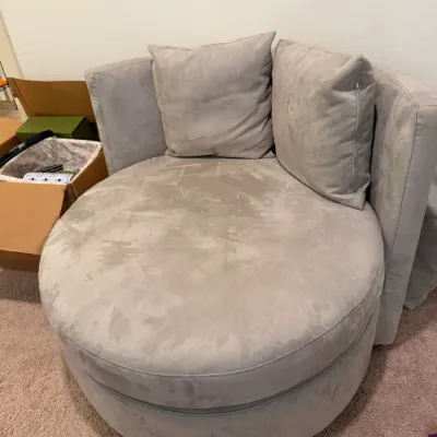 Sale Photo Thumbnail #78: Contemporary oversized circular swivel lounge chair in light grey microfiber upholstery, accompanied by two matching throw pillows.