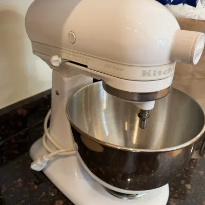 Sale Photo Thumbnail #26: White KitchenAid Ultra Power tilt-head stand mixer with stainless steel mixing bowl.