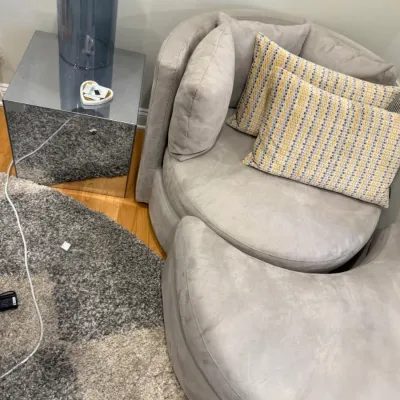 Sale Photo Thumbnail #42: Contemporary light gray swivel lounge chair with matching curved ottoman and accent pillows, paired with a mirrored cube side table.