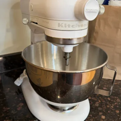 Sale Photo Thumbnail #25: White KitchenAid Ultra Power tilt-head stand mixer with a stainless steel mixing bowl.