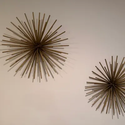 Sale Photo Thumbnail #84: Pair of mid-century modern style brass starburst or urchin wall sculptures, featuring radiating tubular metal rods.