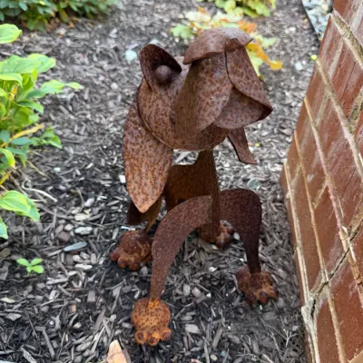 Sale Photo Thumbnail #94: Rustic, weathered metal garden sculpture of a dog featuring a heavy rusted patina and stylized geometric construction.