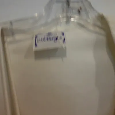 Sale Photo Thumbnail #68: A white garment hanging on a clear plastic hanger with a visible brand tag.