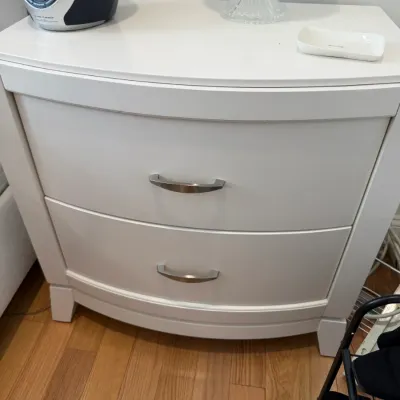 Sale Photo Thumbnail #97: Contemporary white two-drawer nightstand featuring a bowed front profile and brushed metal hardware.