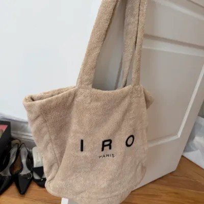 Sale Photo Thumbnail #105: Tan terry cloth tote bag by IRO Paris hanging on a door handle.