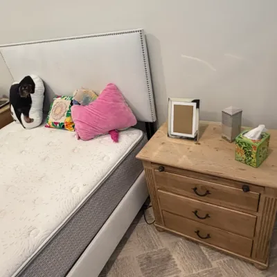 Sale Photo Thumbnail #63: Contemporary queen platform bed frame with a white nailhead-trim upholstered headboard, paired with a matching natural pine three-drawer nightstand.