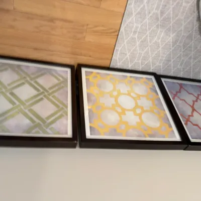 Sale Photo Thumbnail #7: Set of three contemporary framed wall art pieces featuring geometric patterns in green, yellow, and red motifs.