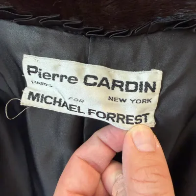 Sale Photo Thumbnail #86: Vintage Pierre Cardin for Michael Forrest dark fur coat tag, showing designer label details on black lining.