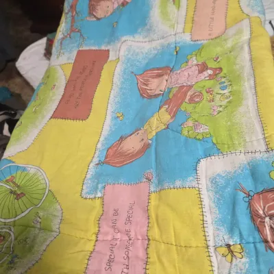 Sale Photo Thumbnail #144: Vintage Holly Hobbie style quilted blanket featuring illustrations and inspirational text blocks, circa 1970s.