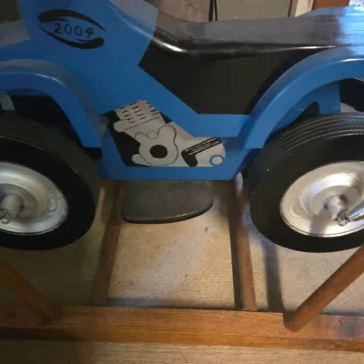 Sale Photo Thumbnail #19: Handcrafted wooden spring-mounted ATV ride-on toy, painted blue and black with the year 2004 marked on the side.