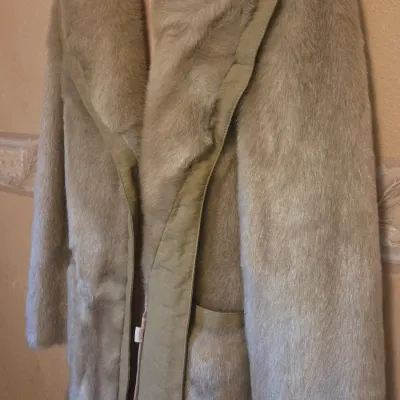 Sale Photo Thumbnail #59: Vintage tan plush faux fur coat featuring a wide shawl lapel collar and leather trim.