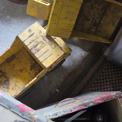 Sale Photo Thumbnail #15: Vintage pressed steel Tonka construction trucks with visible surface rust and wear from age.