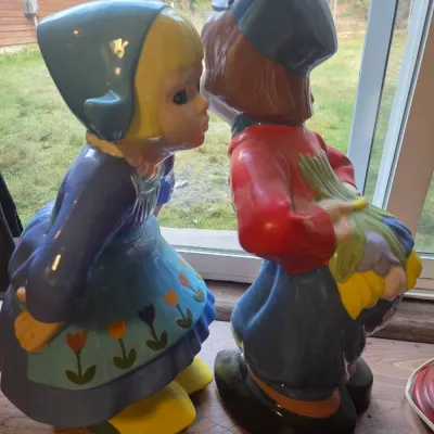 Sale Photo Thumbnail #149: Pair of vintage ceramic Dutch kissing boy and girl statues featuring colorful painted details and a glossy finish.