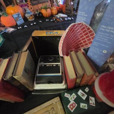 Sale Photo Thumbnail #26: Vintage Kodak EK4 instant camera in original box surrounded by old books, holiday decor, and a Spirits Bright fiber optic tree top angel.