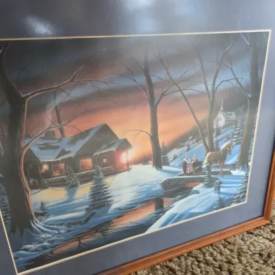 Sale Photo Thumbnail #73: Framed winter landscape art print depicting a snowy cabin and horse-drawn sleigh at sunset, double-matted in a simple wooden frame.