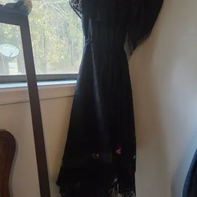 Sale Photo Thumbnail #129: Vintage black Mexican-style dress featuring a lace-trimmed shoulder cape overlay and embroidered floral detailing along the hem.