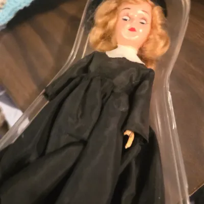 Sale Photo Thumbnail #118: Vintage Storybook-style doll wearing a long black gown and hat, housed in its original clear plastic packaging.