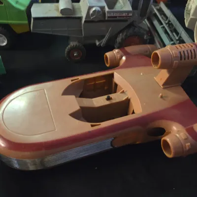 Sale Photo Thumbnail #17: Vintage Kenner Star Wars Landspeeder vehicle toy from the late 1970s, shown missing its windshield and figures among other toy vehicles.