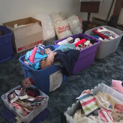 Sale Photo Thumbnail #56: Collection of storage tubs and boxes filled with various fabrics, linens, craft supplies, and sewing notions.