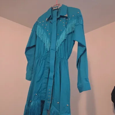 Sale Photo Thumbnail #127: Vintage teal Western dress featuring fringe trim, silver stud accents, and a matching belt.