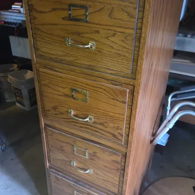 Sale Photo Thumbnail #11: Traditional oak four-drawer vertical file cabinet featuring brass hardware and label holders.