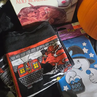 Sale Photo Thumbnail #33: Novelty Halloween items including a fake parody Hamburger Helper box, Halloween-themed printed cloth, and a package of Boo Treats favor bags.