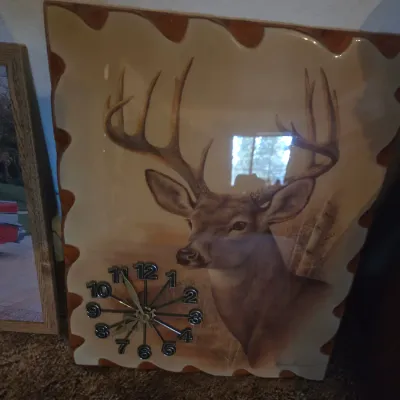 Sale Photo Thumbnail #90: Vintage resin-coated wood slab wall clock featuring a buck deer illustration with applied numerical markers.