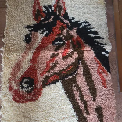 Sale Photo Thumbnail #156: Vintage handmade latch hook rug featuring a horse portrait design in earth tones.