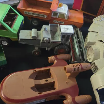 Sale Photo Thumbnail #51: Collection of vintage toys including a Kenner Star Wars Landspeeder, Millennium Falcon, and Nylint pressed steel construction vehicles, circa 1970s.