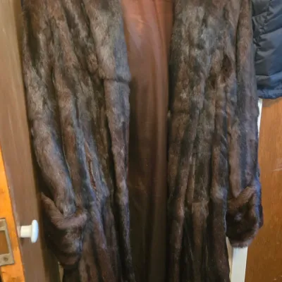 Sale Photo Thumbnail #58: Vintage dark brown full-length fur coat featuring wide lapels, cuffed sleeves, and a matching brown interior lining.