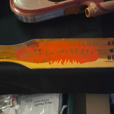 Sale Photo Thumbnail #18: Vintage novelty wooden spanking paddle reading "HEAT for the SEAT! APPLY WHEN NEEDED" from Missoula, Mont., shown alongside a vintage Kenner Star Wars Landspeeder toy.