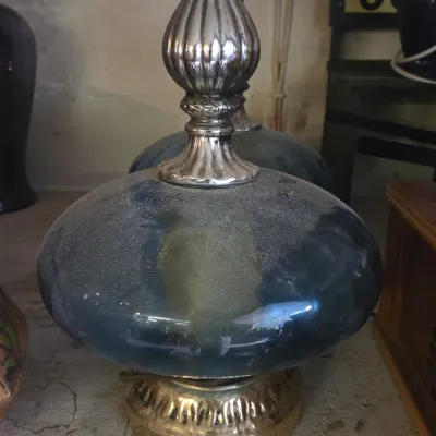 Sale Photo Thumbnail #14: Vintage mid-century table lamp with a blue glass body, fluted metallic accents, and a brass-finished base.