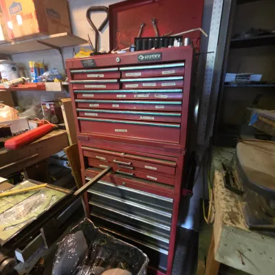Sale Photo Thumbnail #28: Red Husky multi-drawer rolling tool chest combo with hinged top lid, labeled drawers, and visible wear from use.