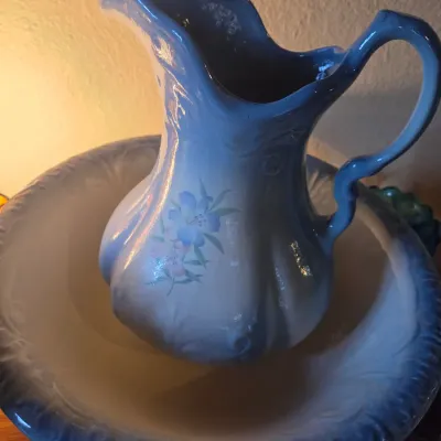 Sale Photo Thumbnail #102: Vintage ceramic wash basin and pitcher set in blue and white with delicate floral decals.