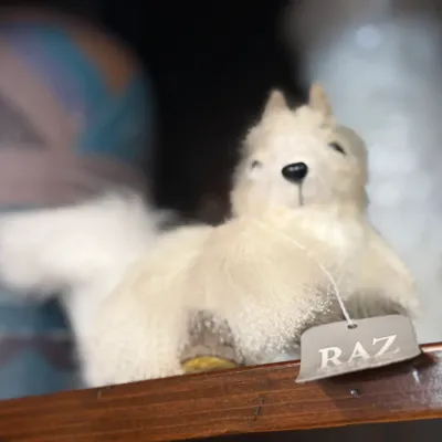 Sale Photo Thumbnail #33: Raz Imports fuzzy white squirrel figurine, displayed on a wooden shelf with original tag.