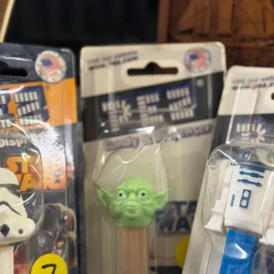 Sale Photo Thumbnail #17: Collection of packaged Star Wars PEZ candy dispensers, including Stormtrooper, Yoda, and R2-D2 characters.