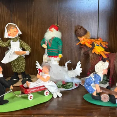 Sale Photo Thumbnail #31: Collection of vintage Annalee Mobilitee dolls and holiday figurines, including a bride in a Radio Flyer wagon, Santa, and Thanksgiving-themed characters.