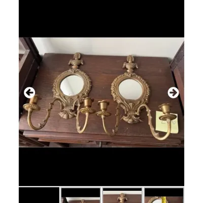 Sale Photo Thumbnail #104: Pair of vintage brass two-arm wall sconces featuring ornate scrollwork and round inset mirrors.