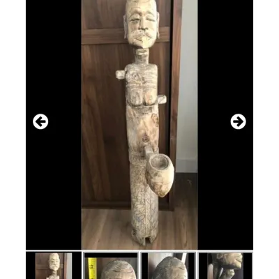 Sale Photo Thumbnail #63: Hand-carved wooden tribal figure, featuring detailed facial features, carved body markings, and an extended forward bowl element.