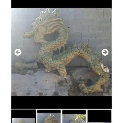 Sale Photo Thumbnail #45: Large cast outdoor dragon sculpture in a pale green finish, showing some wear and damage to the lower limbs.