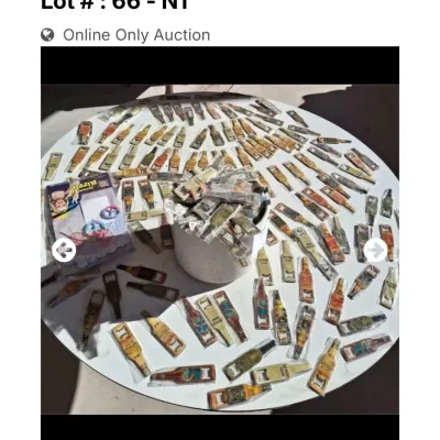 Sale Photo Thumbnail #39: Large collection of vintage novel bottle opener keychains and souvenirs displayed across a round table.