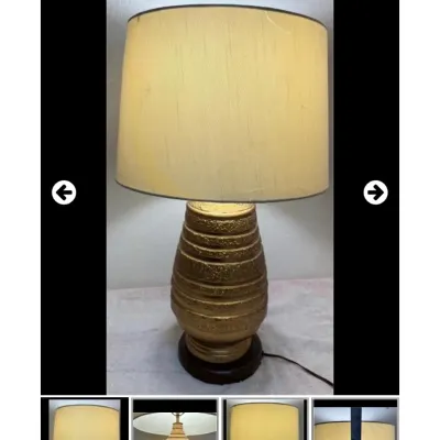 Sale Photo Thumbnail #62: Vintage mid-century modern table lamp featuring a textured gold ceramic body with ribbed details and a drum shade.